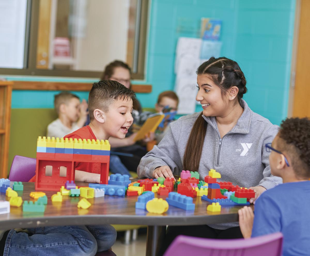 Youth playing blocks with teacher