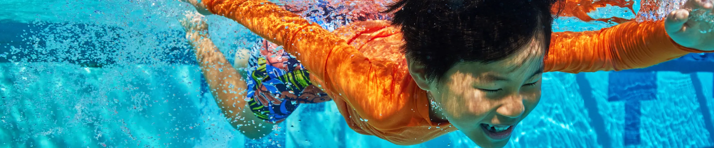 Kid diving underwater