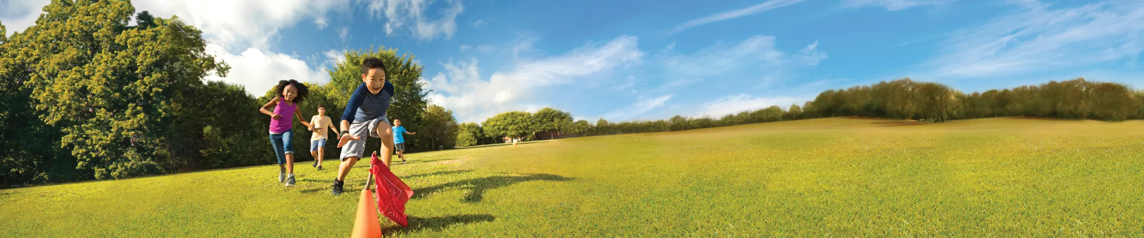 Day Camp image of kid running outside towards an orange cone